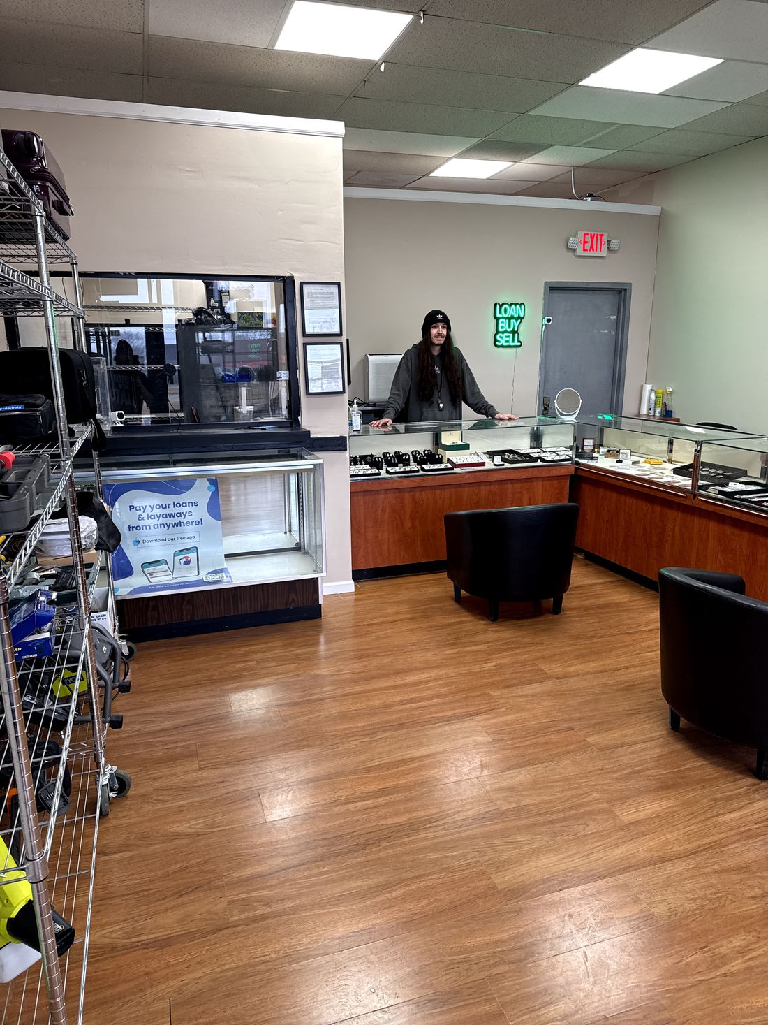 Friendly staff behind the counter inside the Cash Pawn showroom